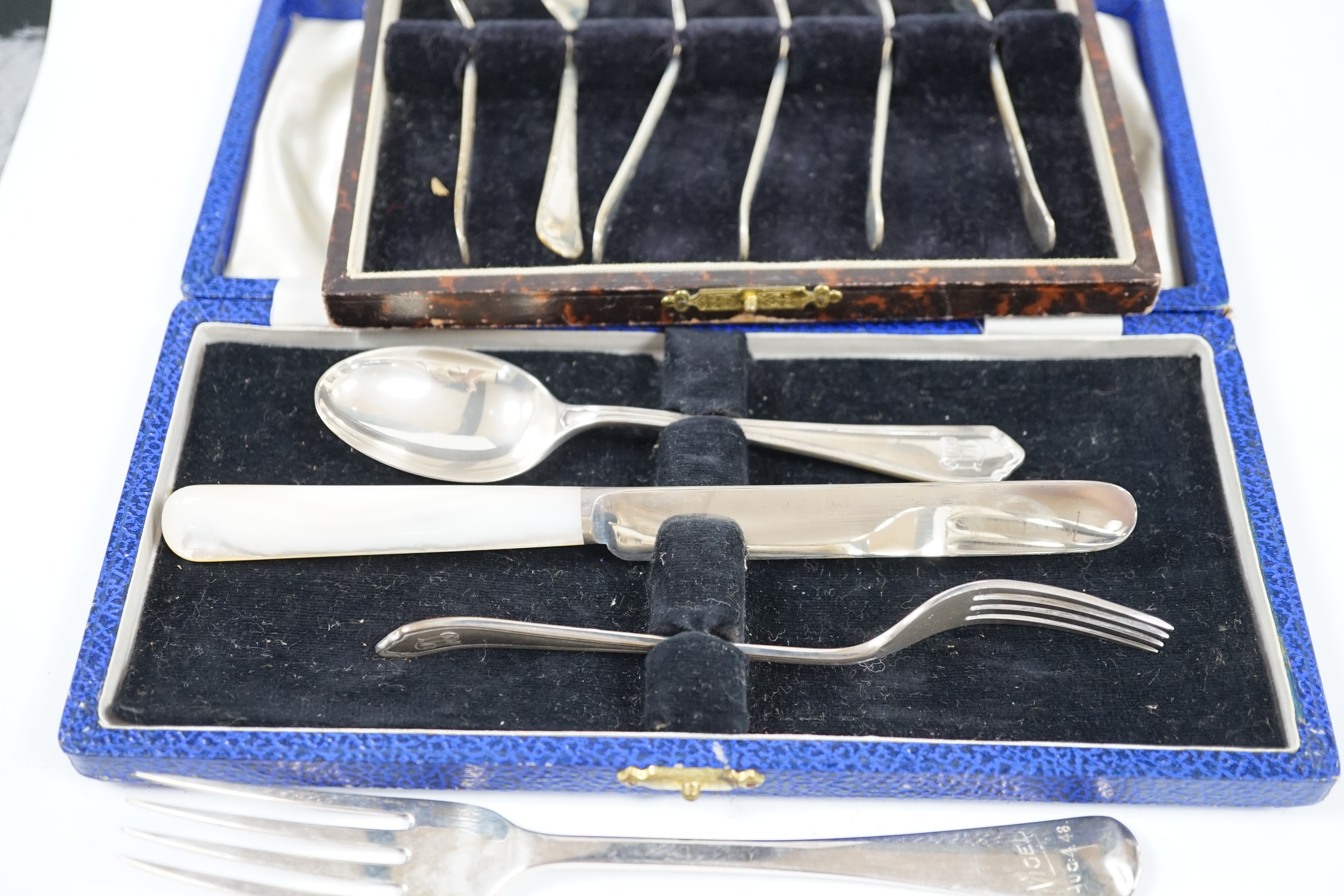 A George VI cased silver christening trio, Sheffield, 1946/7, a matched silver christening pair and a cased set of six silver pastry forks. Condition - fair to good